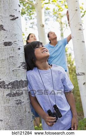 Picture - Boy with binoculars in forest. Fotosearch