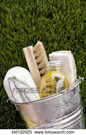 Stock Photography - Bucket of cleaning supplies in grass. Fotosearch