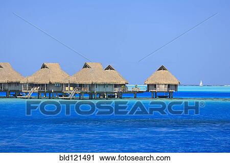 Stock Image - Bungalows over tropical ocean, Bora Bora, French Polynesia. Fotosearch