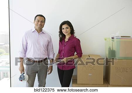 Stock Photography - Business people smiling in new office. Fotosearch