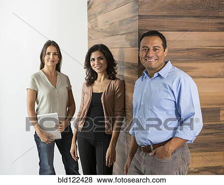 Stock Photo - Business people smiling in office. Fotosearch