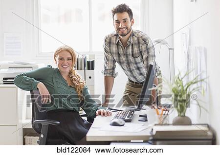 Business people smiling together in office View Large Photo Image Picture - Business people smiling together in office. Fotosearch