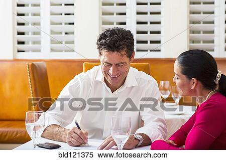 Business people talking at restaurant View Large Photo Image Stock Photography - Business people talking at restaurant. Fotosearch