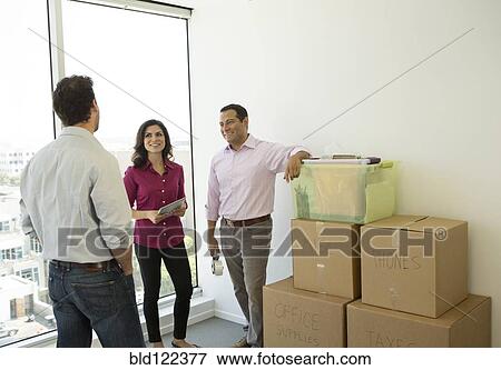 Stock Photo - Business people talking in new office. Fotosearch