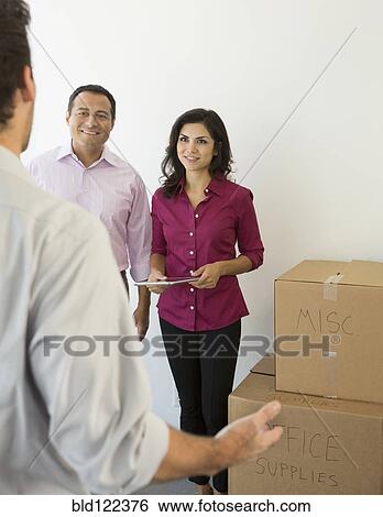 Business people talking in new office View Large Photo Image Stock Photograph - Business people talking in new office. Fotosearch