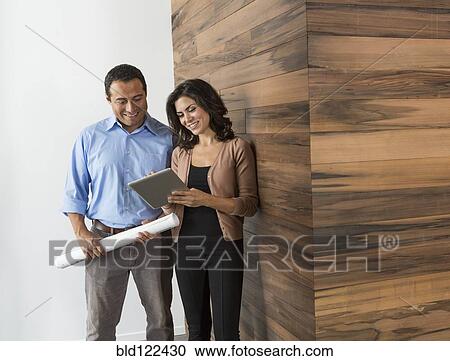 Stock Image - Business people talking in office. Fotosearch