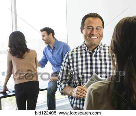 Business people talking in office View Large Photo Image Stock Photo - Business people talking in office. Fotosearch