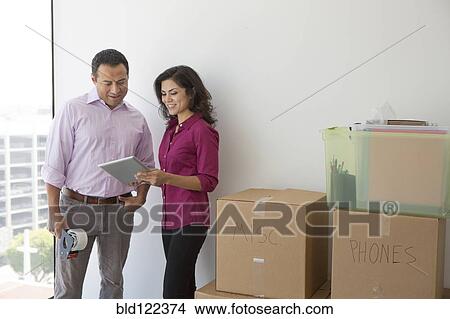 Business people using digital tablet in new office View Large Photo Image Picture - Business people using digital tablet in new office. Fotosearch