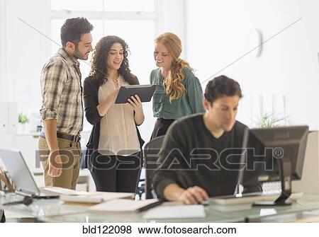 Stock Photo - Business people using digital tablet in office. Fotosearch