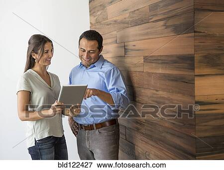Stock Photo - Business people using digital tablet. Fotosearch