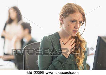 Stock Photography - Businesswoman gasping at computer in office. Fotosearch