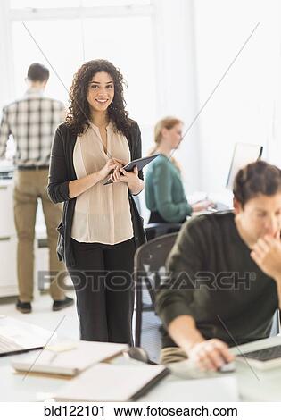 Stock Image - Businesswoman using digital tablet in office. Fotosearch