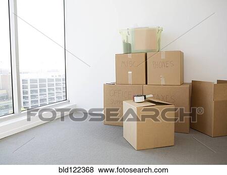 Stock Photo - Cardboard boxes in new home. Fotosearch