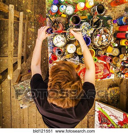 Stock Image - Caucasian artist working in studio. Fotosearch