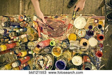 Stock Image - Caucasian artist working in studio. Fotosearch