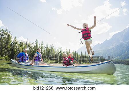 Caucasian boy jumping from canoe into lake View Large Photo Image Stock Photograph - Caucasian boy jumping from canoe into lake. Fotosearch