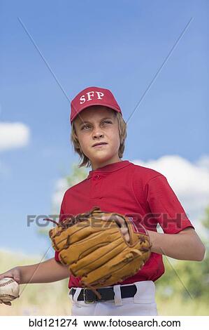 Picture - Caucasian boy playing baseball outdoors. Fotosearch