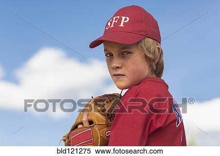Stock Photography - Caucasian boy playing baseball outdoors. Fotosearch