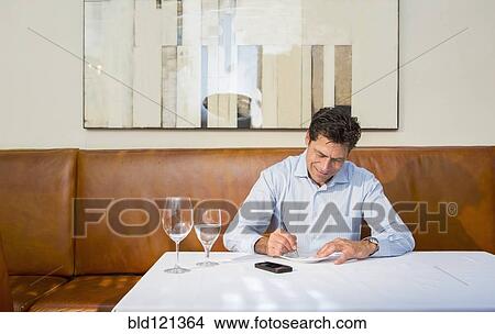 Picture - Caucasian businessman working at restaurant. Fotosearch