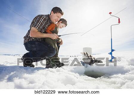 Caucasian father and son ice fishing View Large Photo Image Stock Photo - Caucasian father and son ice fishing. Fotosearch