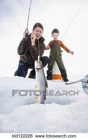 Caucasian father and son ice fishing View Large Photo Image Stock Photograph - Caucasian father and son ice fishing. Fotosearch
