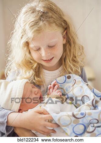 Caucasian girl holding newborn baby brother View Large Photo Image Picture - Caucasian girl holding newborn baby brother. Fotosearch