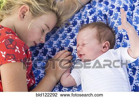 Caucasian girl laying with newborn baby brother View Large Photo Image Stock Image - Caucasian girl laying with newborn baby brother. Fotosearch