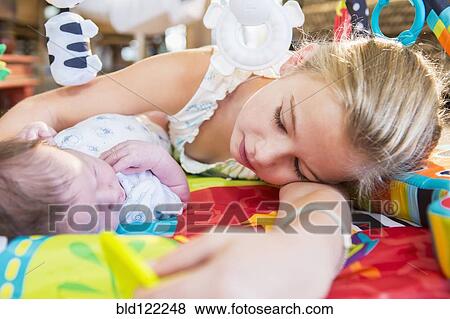 Caucasian girl laying with newborn baby brother View Large Photo Image Stock Photo - Caucasian girl laying with newborn baby brother. Fotosearch