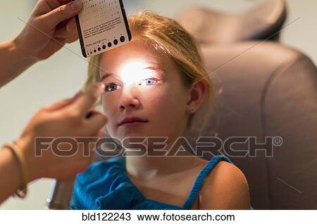 Caucasian girl receiving eye exam View Large Photo Image Stock Image - Caucasian girl receiving eye exam. Fotosearch