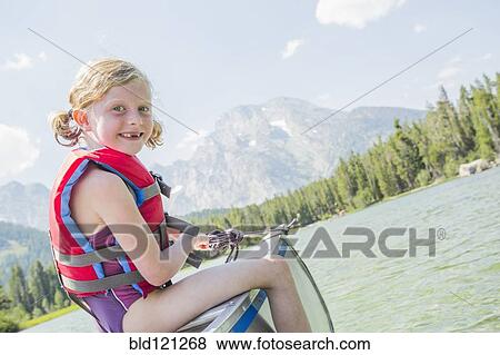 Caucasian girl sitting in canoe on lake View Large Photo Image Stock Photo - Caucasian girl sitting in canoe on lake. Fotosearch