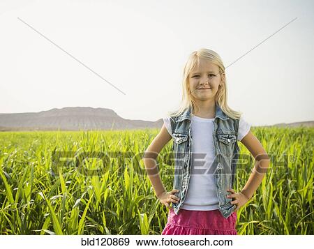 Stock Photo - Caucasian girl smiling in corn field. Fotosearch