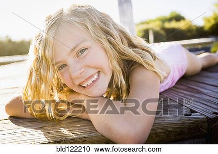 Caucasian girl smiling on dock View Large Photo Image Stock Image - Caucasian girl smiling on dock. Fotosearch