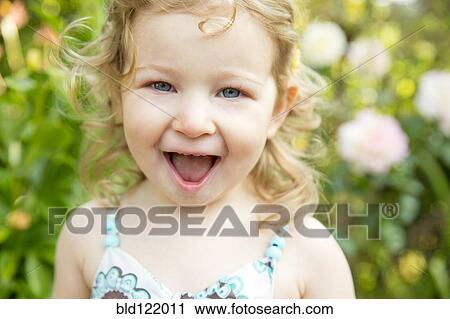 Caucasian girl smiling outdoors View Large Photo Image Stock Image - Caucasian girl smiling outdoors. Fotosearch