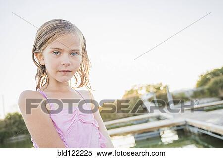 Caucasian girl standing at lakeside View Large Photo Image Stock Photography - Caucasian girl standing at lakeside. Fotosearch