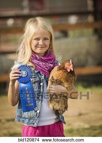 Caucasian girl with prize winning chicken on farm View Large Photo Image Picture - Caucasian girl with prize winning chicken on farm. Fotosearch
