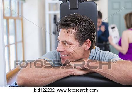 Caucasian man exercising in gym View Large Photo Image Stock Image - Caucasian man exercising in gym. Fotosearch