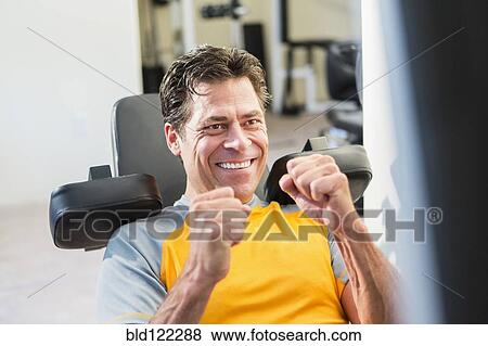 Caucasian man exercising in gym View Large Photo Image Stock Photo - Caucasian man exercising in gym. Fotosearch