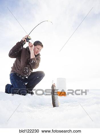 Caucasian man ice fishing View Large Photo Image Stock Image - Caucasian man ice fishing. Fotosearch