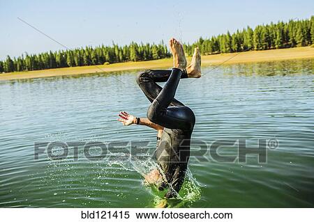 Caucasian man jumping into rural lake View Large Photo Image Stock Photography - Caucasian man jumping into rural lake. Fotosearch