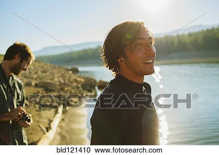Caucasian men standing by rural lake View Large Photo Image Stock Image - Caucasian men standing by rural lake. Fotosearch