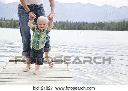 Caucasian mother and baby on dock over lake View Large Photo Image Stock Photo - Caucasian mother and baby on dock over lake. Fotosearch