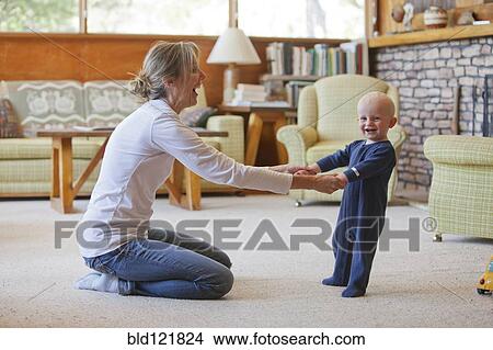 Caucasian mother and baby playing in living room View Large Photo Image Picture - Caucasian mother and baby playing in living room. Fotosearch