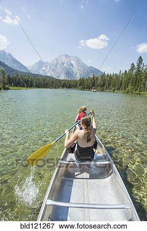 Caucasian mother and daughter paddling canoe on lake View Large Photo Image Stock Photo - Caucasian mother and daughter paddling canoe on lake. Fotosearch