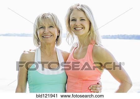Stock Image - Caucasian mother and daughter smiling outdoors. Fotosearch