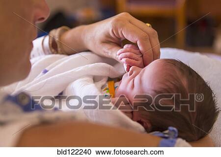 Caucasian mother holding newborn baby View Large Photo Image Stock Image - Caucasian mother holding newborn baby. Fotosearch