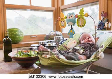 Stock Photograph - Caucasian newborn sleeping in baby seat. Fotosearch