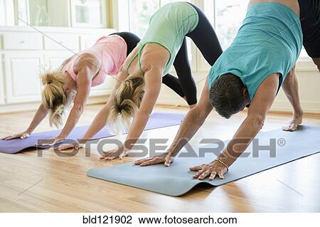 Caucasian people practicing yoga in class View Large Photo Image Stock Image - Caucasian people practicing yoga in class. Fotosearch