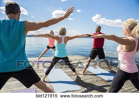 Caucasian people practicing yoga on wooden dock View Large Photo Image Stock Photography - Caucasian people practicing yoga on wooden dock. Fotosearch