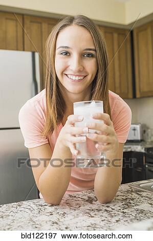 Caucasian woman drinking glass of water View Large Photo Image Stock Photo - Caucasian woman drinking glass of water. Fotosearch
