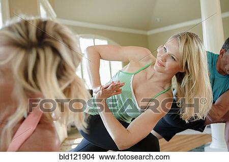 Caucasian woman practicing yoga in class View Large Photo Image Picture - Caucasian woman practicing yoga in class. Fotosearch